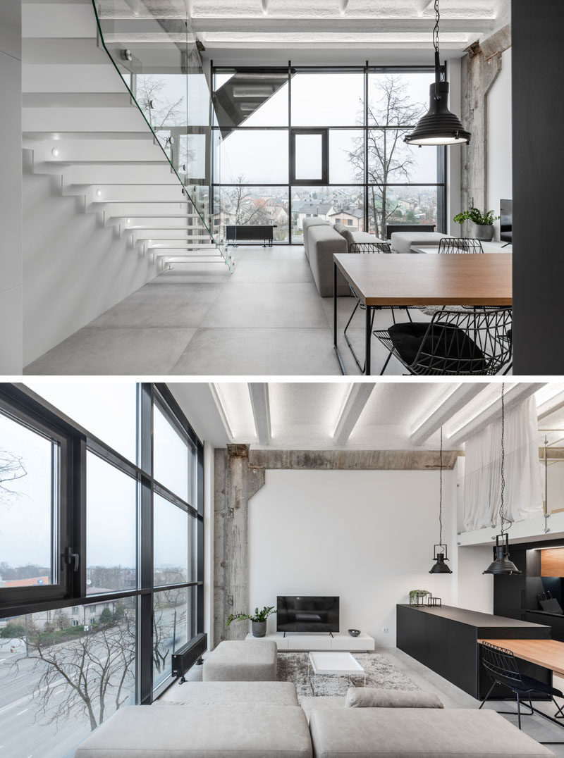 Remnants of raw concrete and a large wall of windows have been combined with fresh white walls and modern furnishings, in this modern loft. #LoftApartment #ModernApartment #LivingRoom
