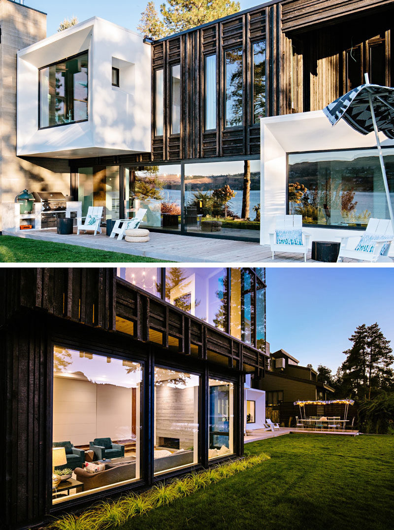 The exterior of this modern lake house is made up of charred cedar cladding treated in the traditional Japanese style of Shou Sugi Ban and a textureless pure white finish. #ModernHouse #Architecture #HouseDesign