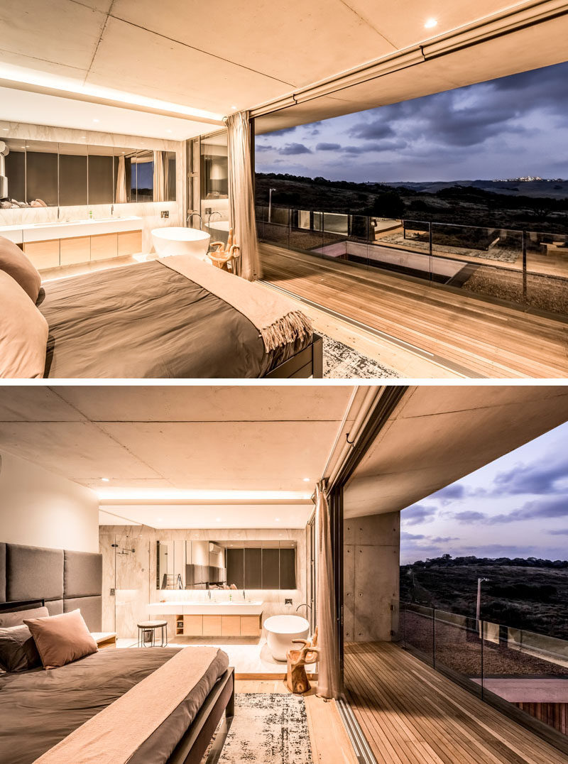 This modern master bedroom has an open ensuite bathroom, and a sliding glass wall that can be opened to the outdoors. #MasterBedroom #EnsuiteBathroom #InteriorDesign