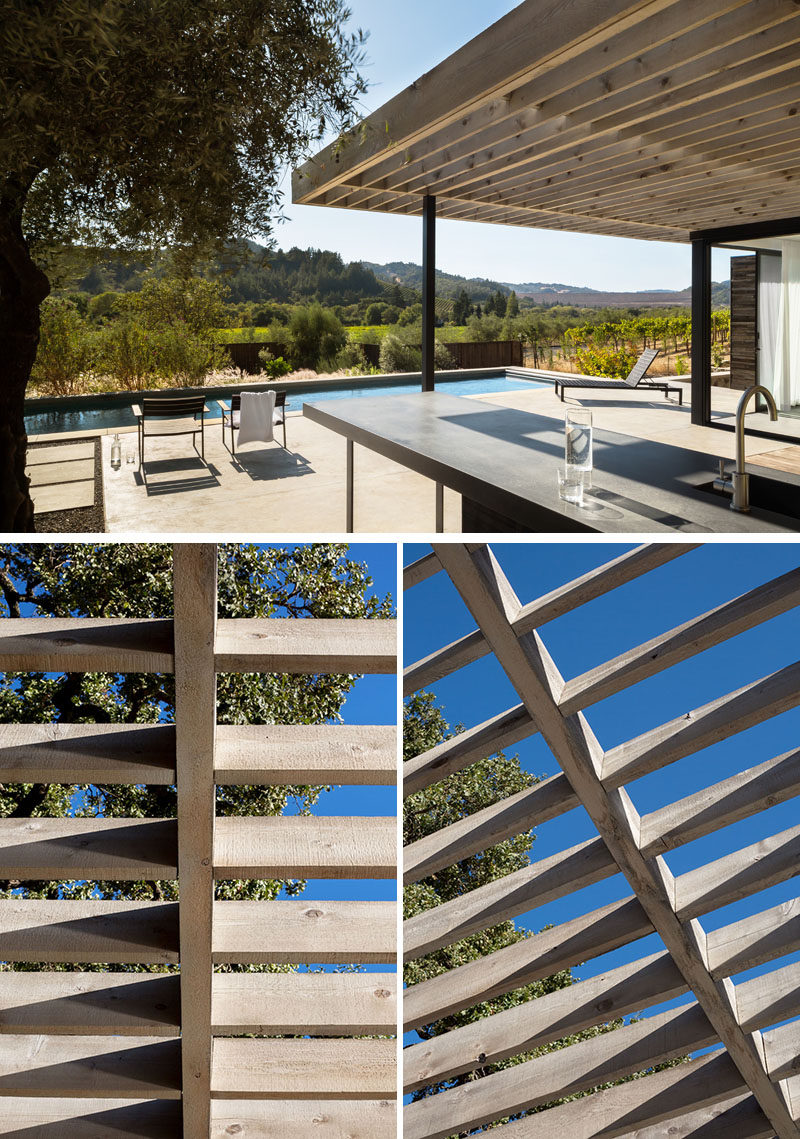 Large sliding doors connect the interior spaces of this modern pool house with the semi-covered outdoor terrace, that has an outdoor kitchen and views of the surrounding area. #Pergola #PoolHouse