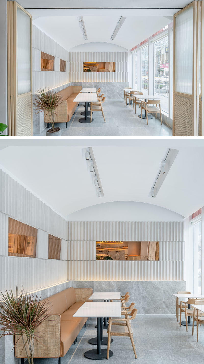 This modern tea house has a lounge room with a curved vaulted ceiling, and a long couch that runs the length of the wall. The doors can be closed when required for meetings and small events. #CafeDesign #RestaurantDesign #InteriorDesign