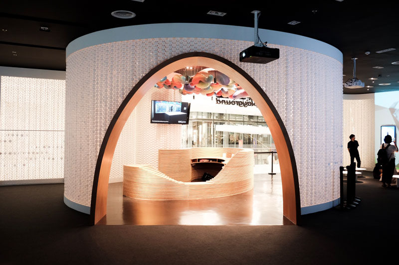 A wooden arch complements the wood reception desk of this playspace, and provides an entryway to the interior space. #Arch #RetailDesign #InteriorDesign