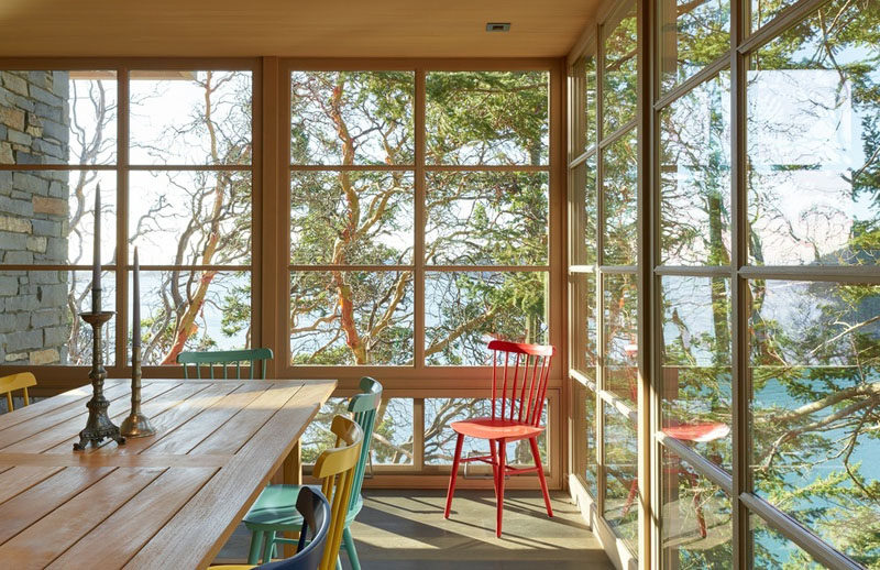 This contemporary dining room has wood-framed windows on three sides. #DiningRoom #Windows