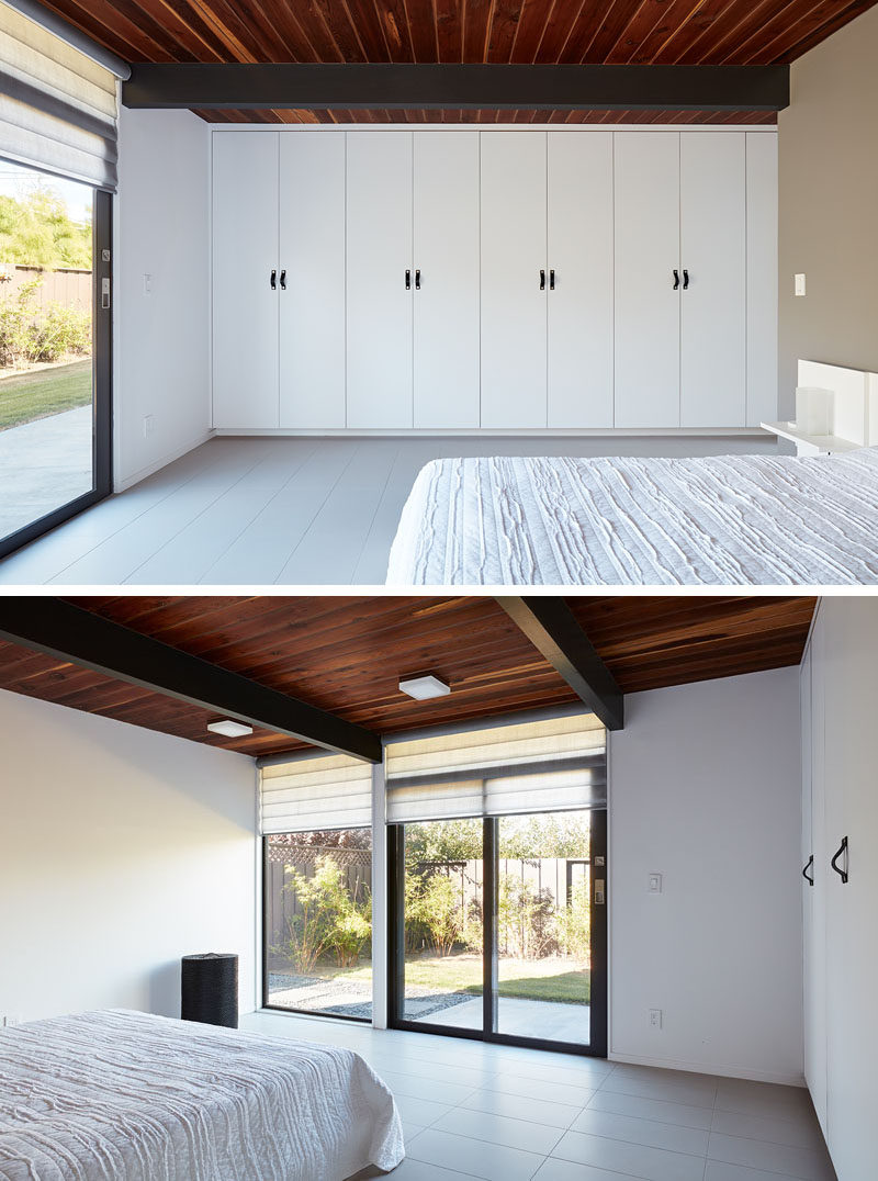 In this simple bedroom, a wall of cabinetry provides plenty of storage, while a window and sliding glass door provides natural light and access to the garden. #Bedroom #Closets #Windows