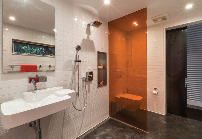 This modern bathroom features stained concrete floors with radiant heating. #ModernBathroom #ConcreteFloors
