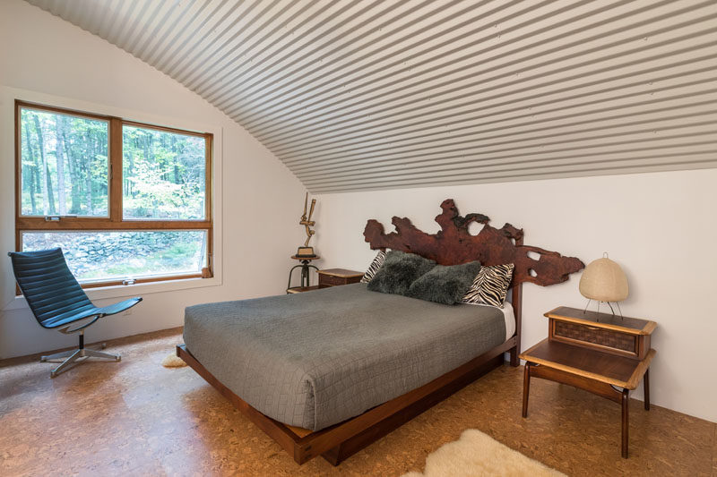 This modern bedroom has a window for treetop views, and a curved ceiling due to the shape of the hut its in. #Bedroom