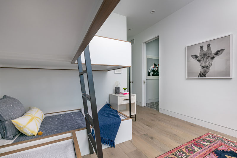 In this modern bedroom, minimalist bunk beds line one of the corners. #Bedroom #BunkBeds