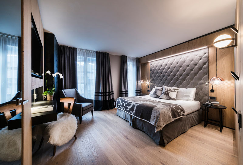 This modern hotel room features upholstered headboards that are built into the wood walls. #Bedroom #Headboard #InteriorDesign