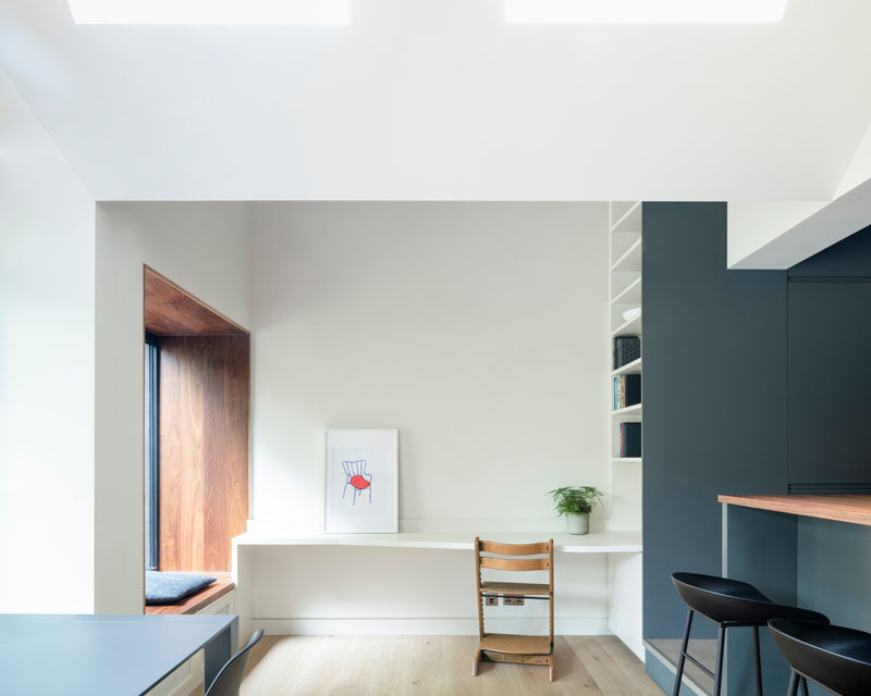 This small desk area has a built-in bookshelf at one end and a wood-lined window seat at the other. #HomeOffice #Bookshelf #WindowSeat