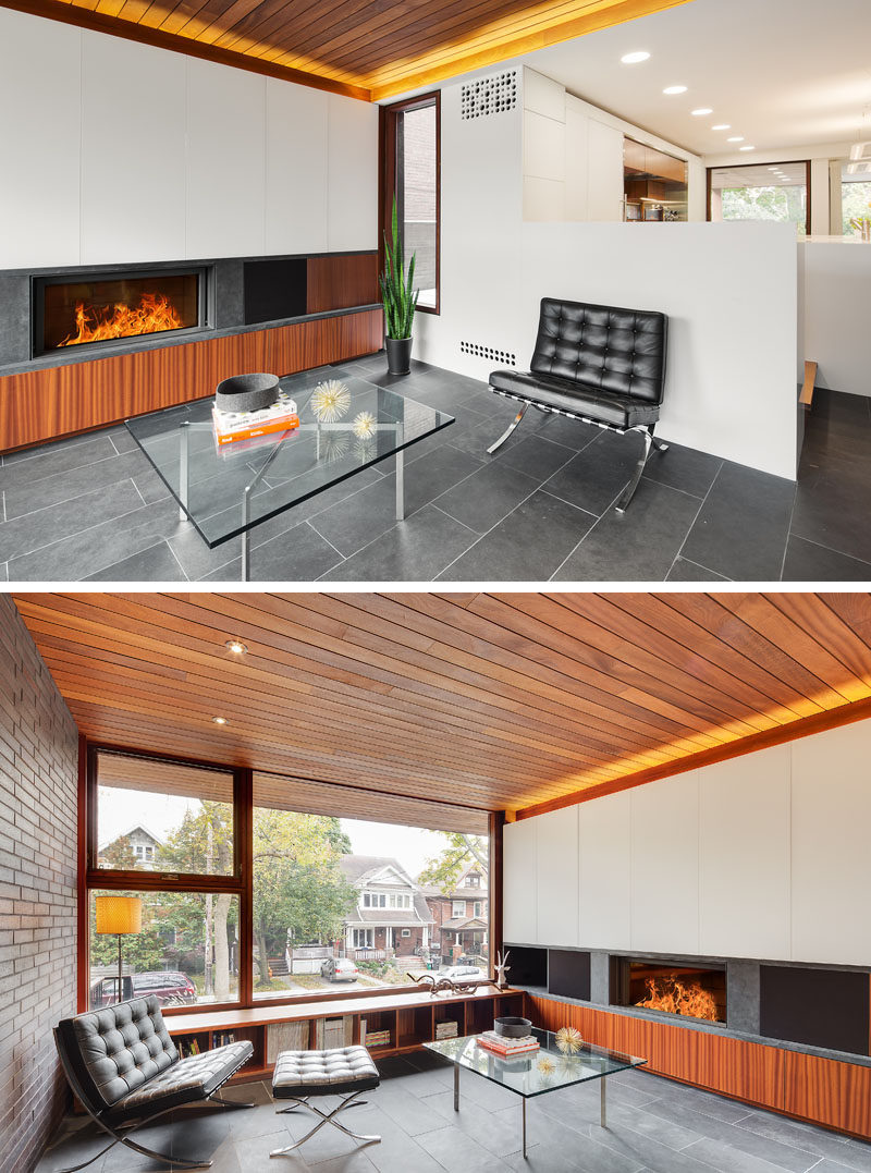 This modern living room has a wood ceiling, a fireplace, and views of the street. #LivingRoom #Fireplace