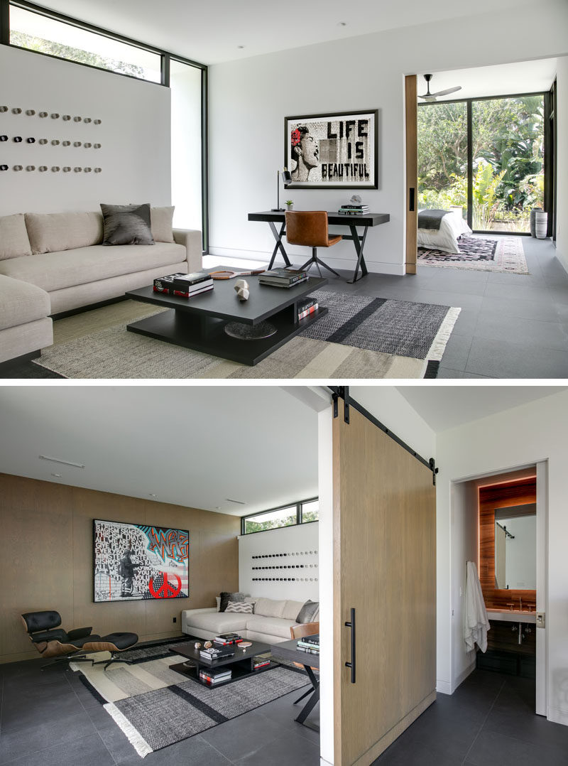 In this modern master suite, there's a private living room with a large sliding wood door separating it from the sleeping area. #MasterSuite #BedroomSuite #LivingRoom #SlidingDoor