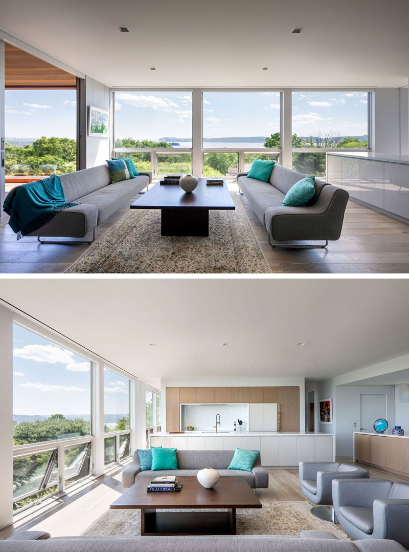 Floor-to-ceiling windows maximize the panoramic views of the town and river below. #Windows #LivingRoom #InteriorDesign #ModernInterior