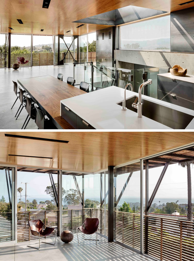 A modern kitchen with an island that include a wood dining table in its design. 