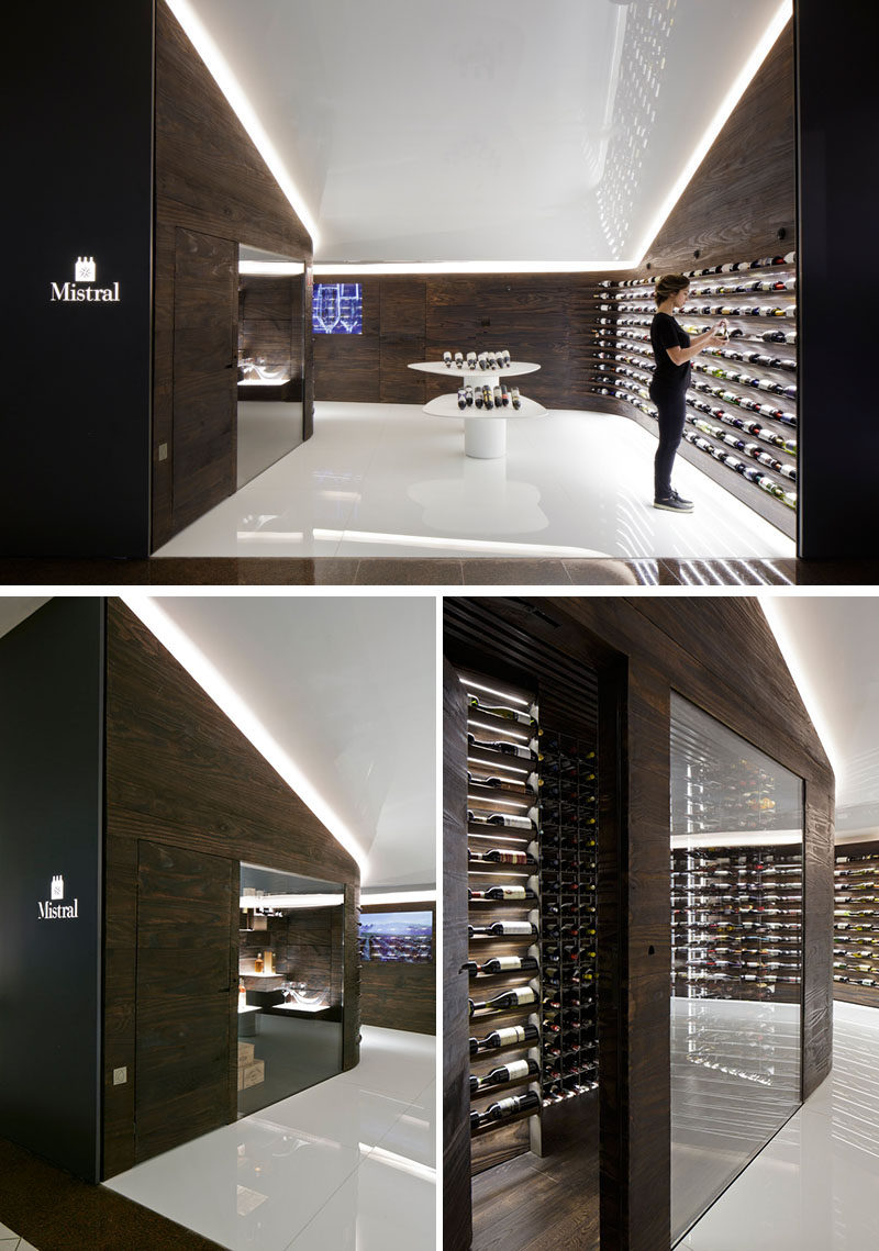 Studio Arthur Casas have designed a wine store and bar in Sao Paulo, Brazil, that features walls of dark wood that showcase the available wines. #WineStore #RetailDesign #WineBar #WineStorage