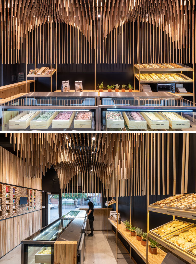 This modern retail store features 1954 broomsticks (commemorating the year of the founding of the family business), that were used to create a sculptural wood ceiling installation. #ModernRetailStore #StoreDesign #WoodCeiling