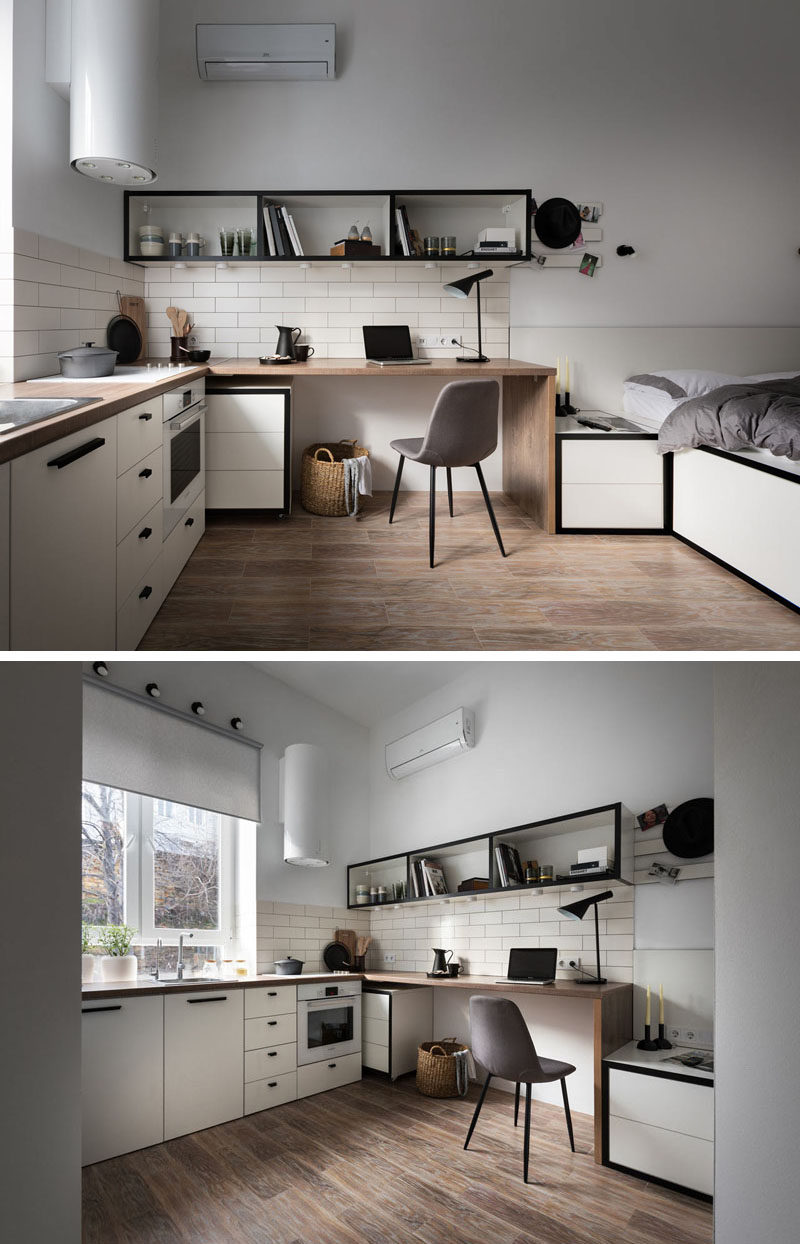 In this small apartment, the wood desktop morphs into the kitchen counter, that features a minimalist cooktop. A tall window allows for natural light to fill the small space, while cabinets and drawers below, create extra storage space. #Desk #SmallApartment #Kitchen