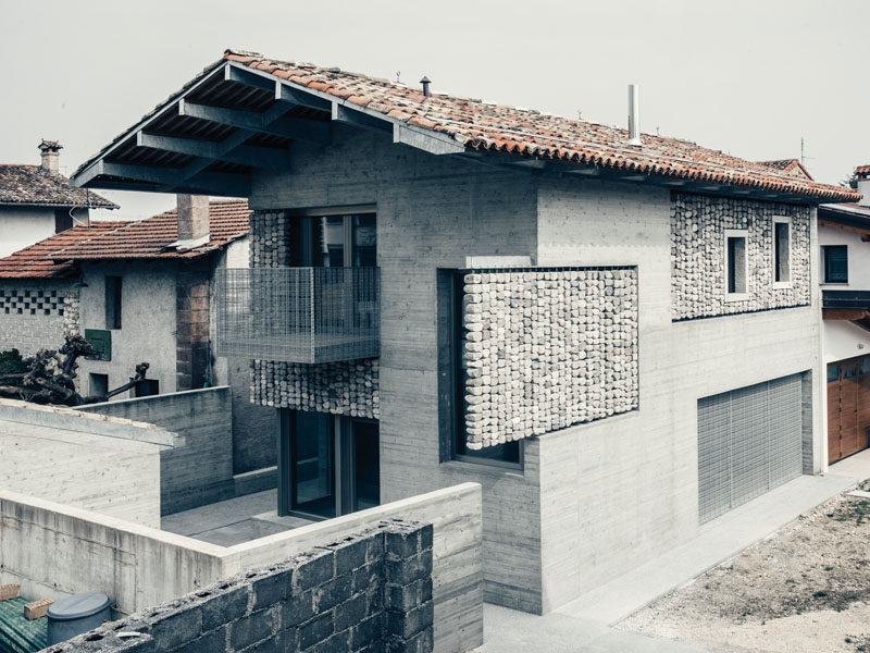 This renovated concrete house features stone curtains that add interest to the facade of the home, and create interesting patterns inside when the sunlight hits them. #Architecture #Facade #Stone