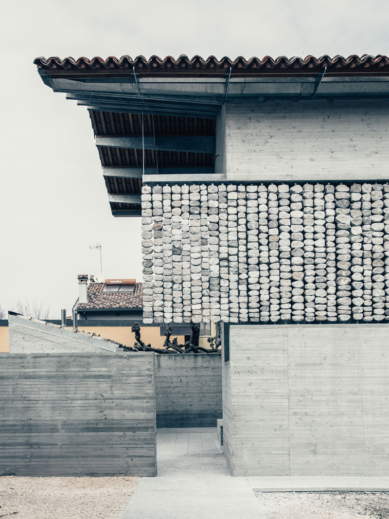 This renovated concrete house features stone curtains that add interest to the facade of the home, and create interesting patterns inside when the sunlight hits them. #Architecture #Facade #Stone