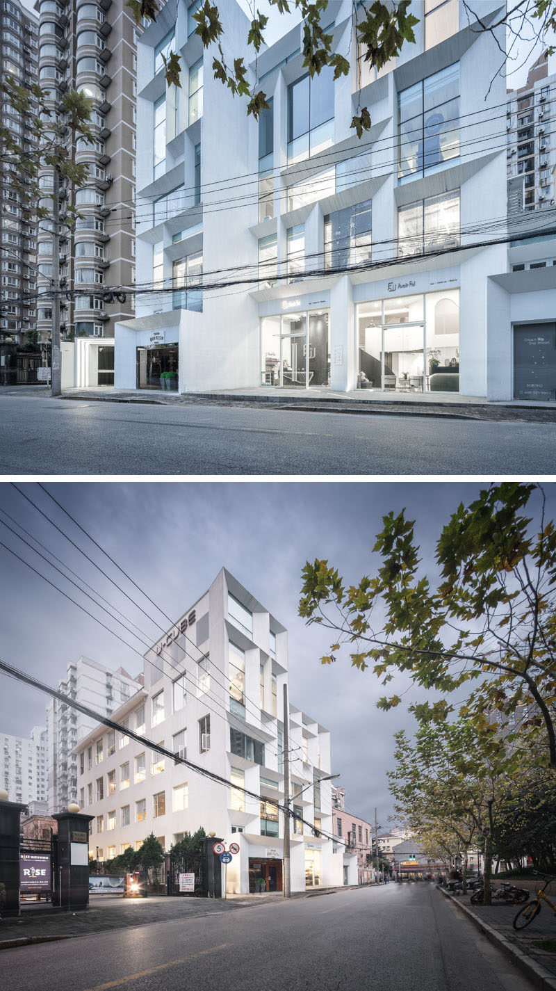 The simple white exterior of this modern office building features angled frames, and is like a beacon of light for the surrounding neighborhood. #ModernOfficeBuilding #Architecture