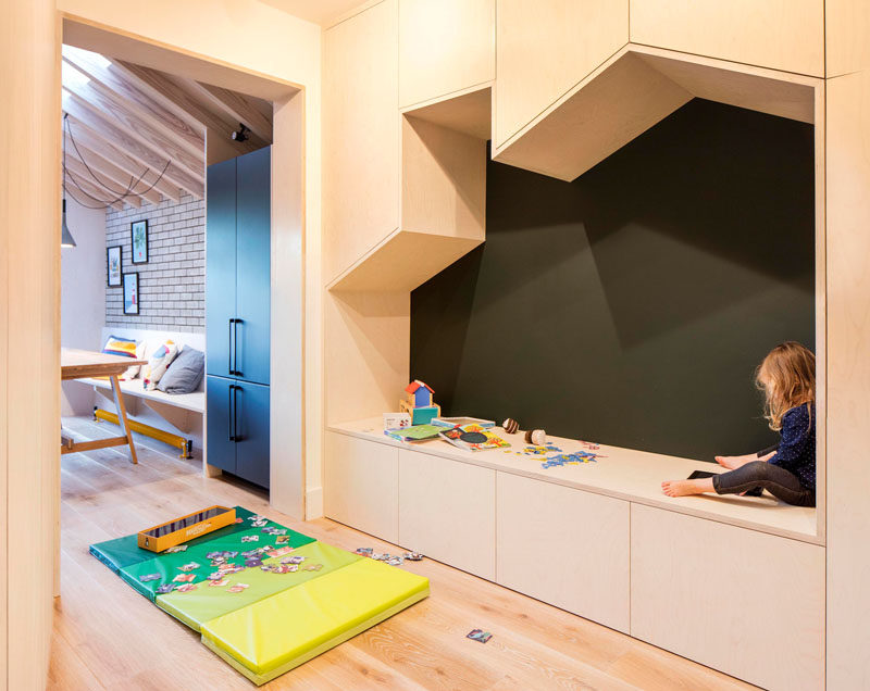 Adjacent to the dining area int his updated home by Woodrow Architects, is a small playroom with a built-in seating nook in the shape of a house, that's surrounded by storage cabinets. #BuiltInSeating #PlayRoom Visit Woodrow Architect's website here > https://www.wdrw.co.uk