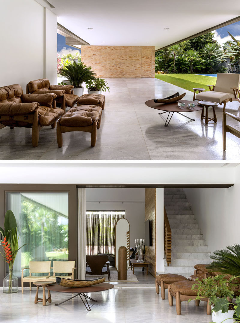 This modern covered patio area, which flows beneath the upper floor of the home, has a lounge area for relaxing. #Architecture