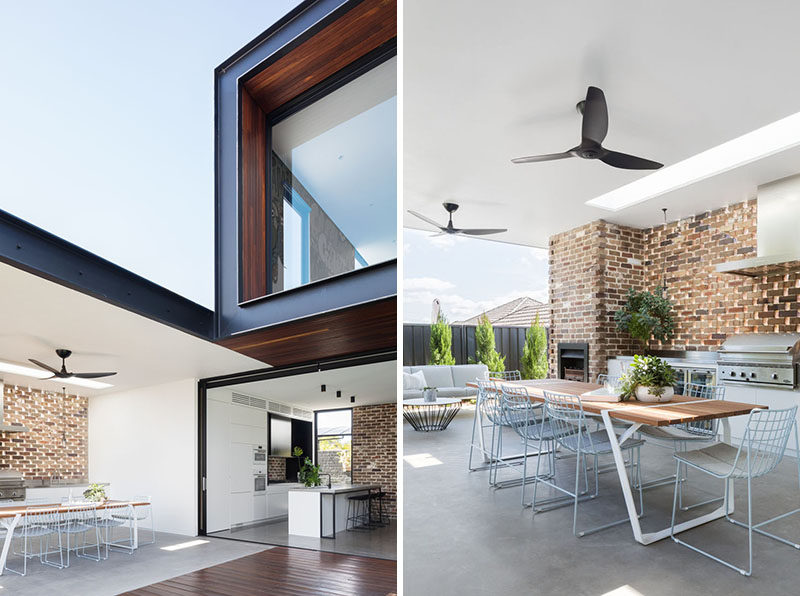 Large sliding doors connect the kitchen to a covered alfresco dining area with an outdoor kitchen. #AlfrescoDining #OutdoorKitchen