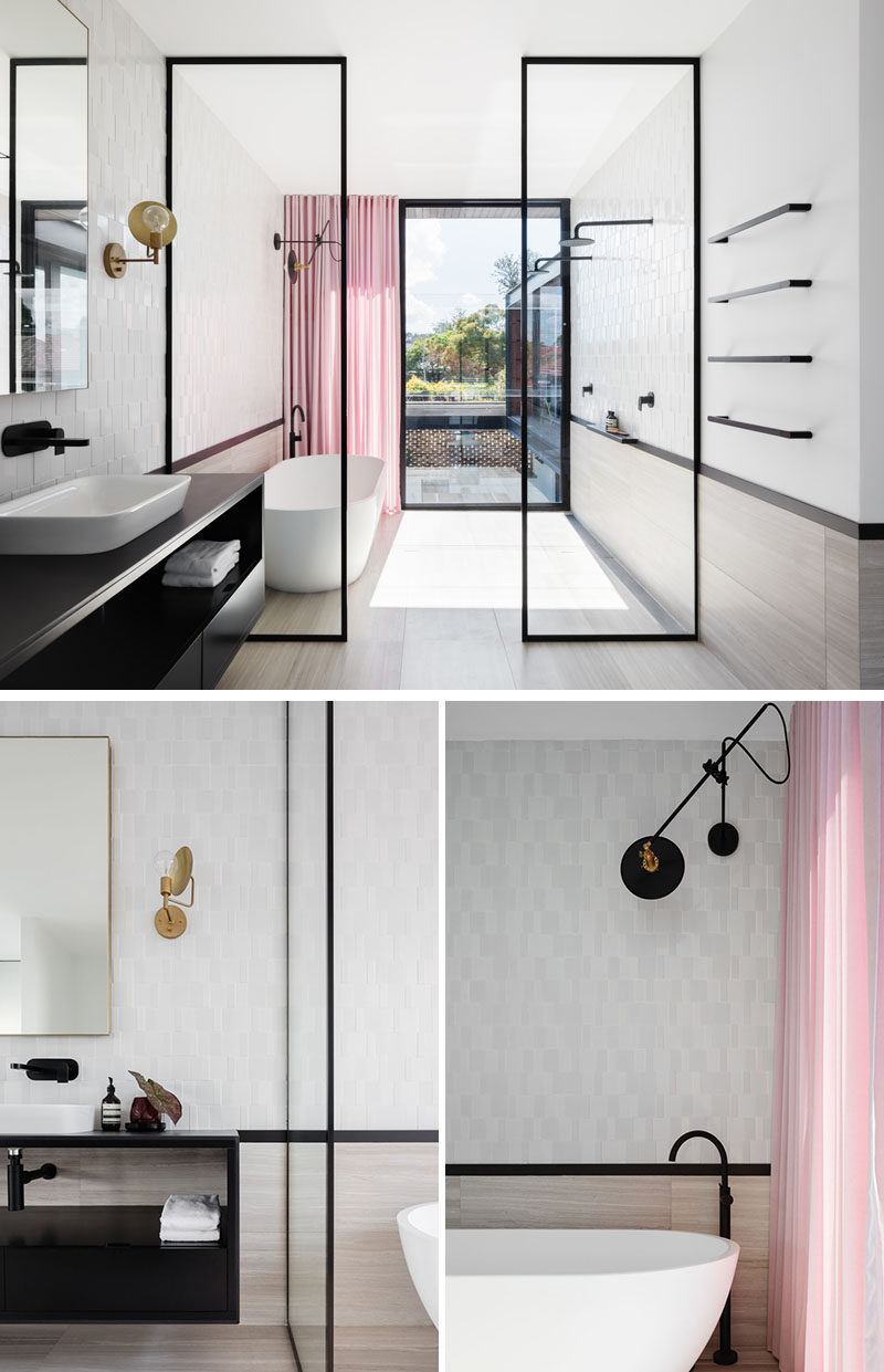 In the master bathroom, black-framed glass shower screens separate the wet areas of the bathroom from the dry. Pink curtains at the end of the bathroom add a soft and colorful touch to the space. #ModernBathroom #BathroomDesign