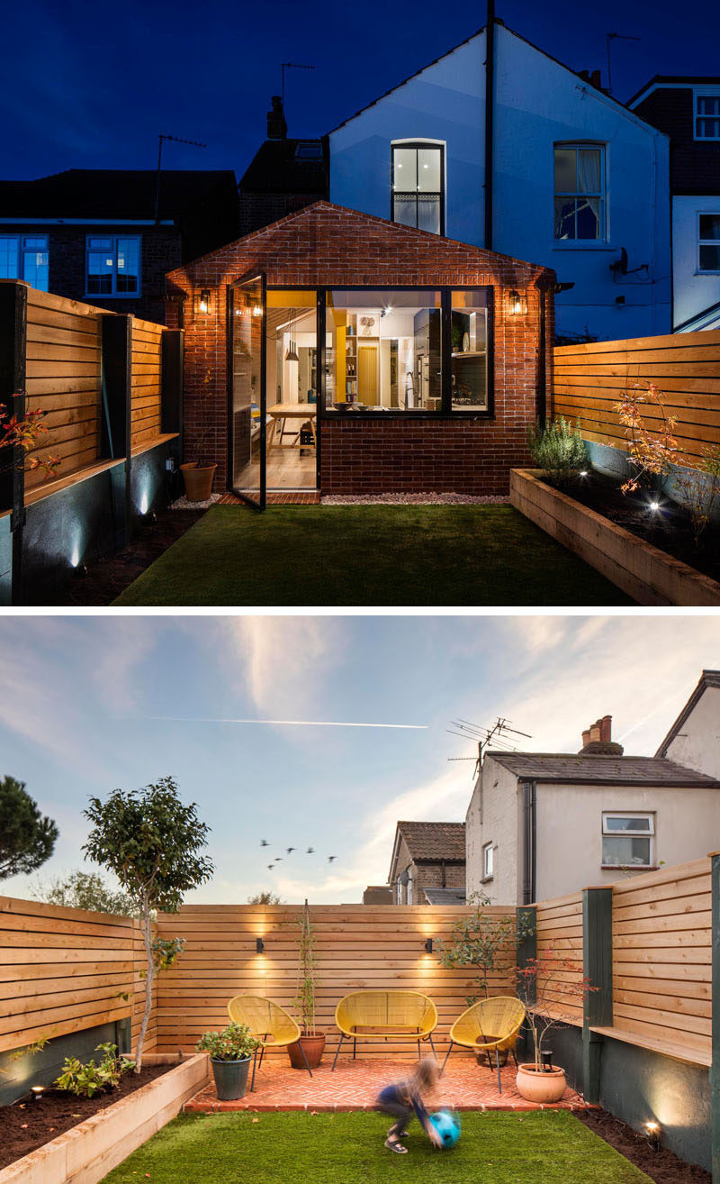 This brick extension by Woodrow Architects opens up to a small landscaped yard with a raised planter bed on one side, and a patio area at the back. #BrickExtension #Backyard #Patio Visit Woodrow Architect's website here > https://www.wdrw.co.uk