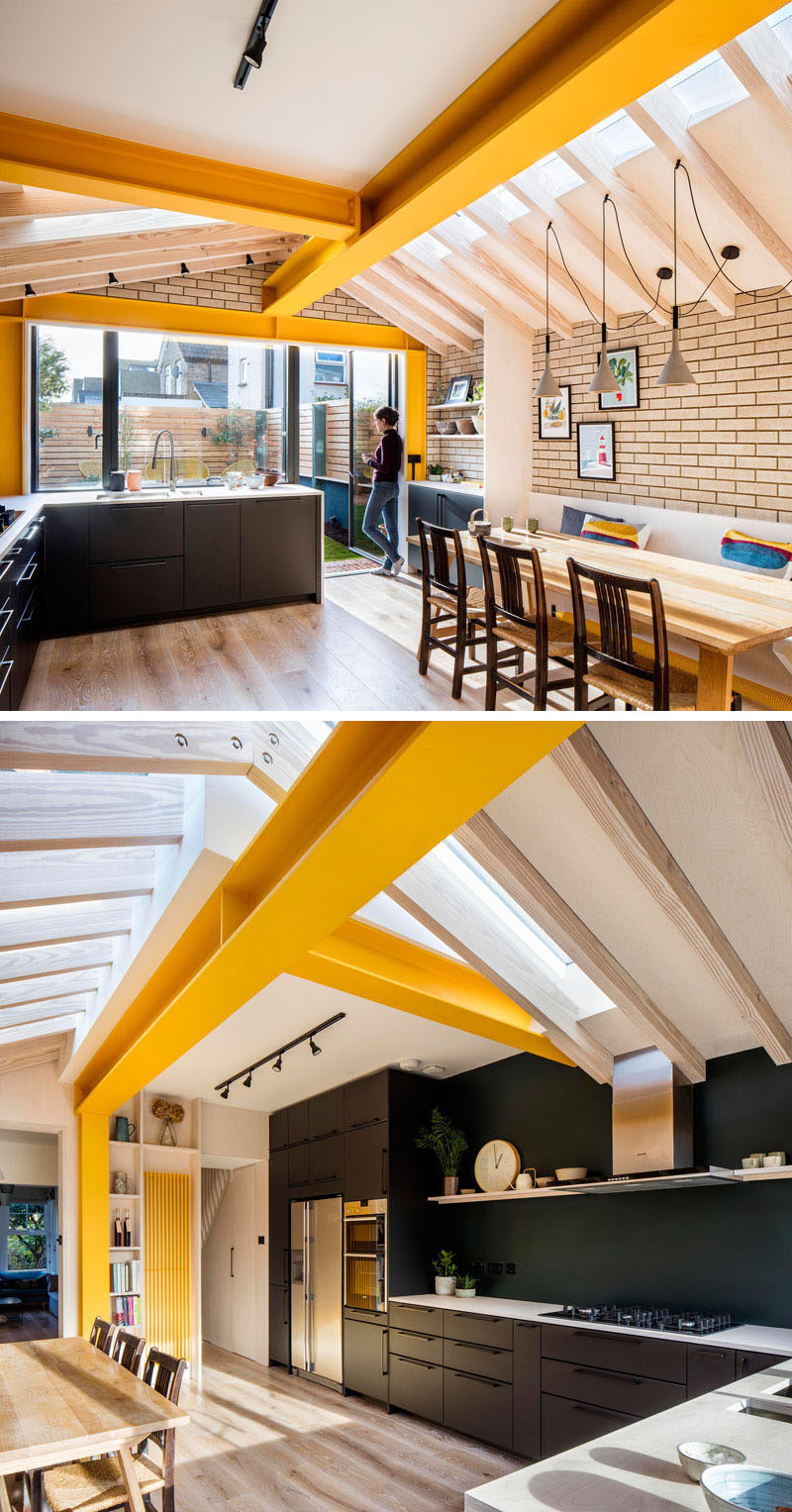 Inside this brick extension by Woodrow Architects, large yellow steel beams provide support, while unconnected rafters sail over with steel plate apex connections allowing the design to do away with any ridge beam.# #YellowBeams #BlackKitchen #BrickExtension Visit Woodrow Architect's website here > https://www.wdrw.co.uk