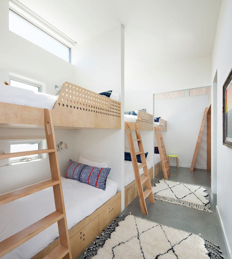 This modern house has a ‘bunk room’, with three double bunks and one loft, sleeping a total of seven. Each of the bunks has its own small window and reading light. #BunkBeds #Bedroom