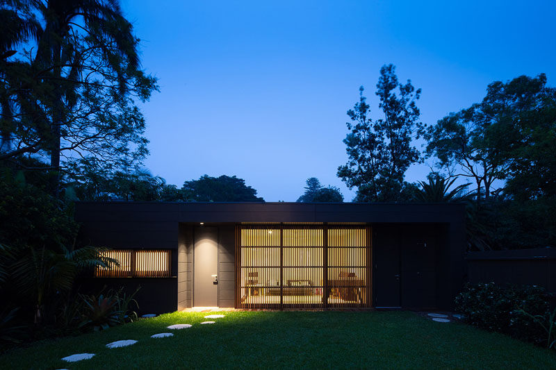 A stepping stone path along the side of this backyard leads to a detached recreation room. #RecRoom #Architecture