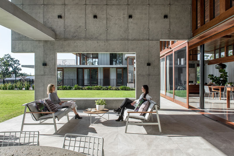 This modern house has a covered patio that provides a place for people to relax in the shade. #Patio #ModernHouse #Architecture