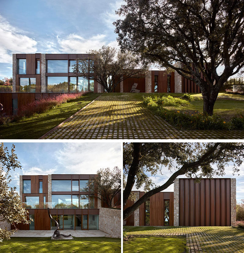 Surrounded by lush vegetation and some ancient Holm oak trees, this modern house was designed around the trees to respect the land. #ModernHouse #Architecture