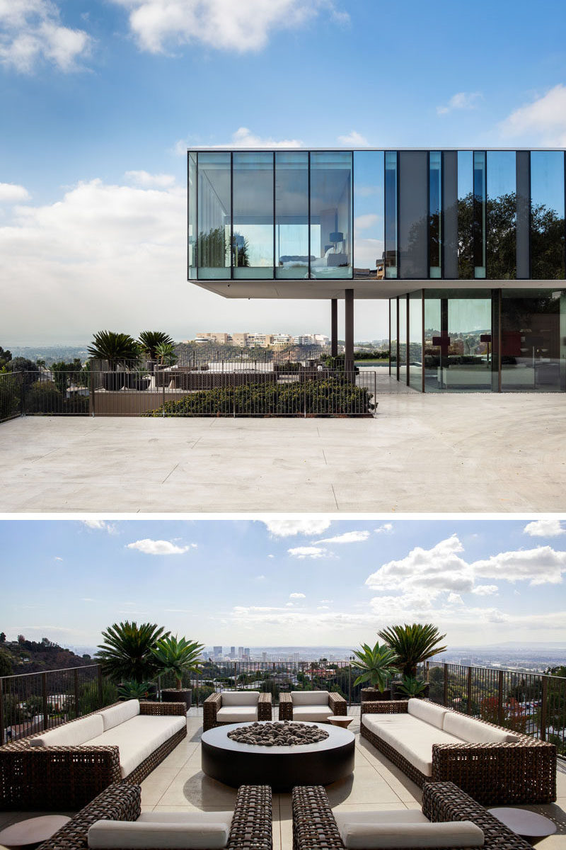 When approaching this modern house, there's a large driveway with a central tree, and adjacent to the driveway, is an outdoor lounge that sits below a cantilevered section of the top floor of the home that houses a bedroom. #OutdoorLounge #Architecture #ModernHouse