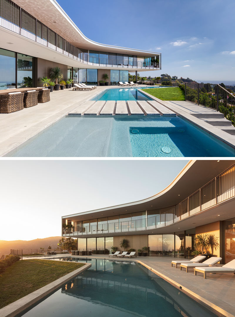 This modern house has an expansive outdoor area that's ideal for entertaining, and includes a kitchen, two fire pits, and an LED-lit pool, as well as uninterrupted views of Los Angeles in the distance. #ModernHouse #OutdoorSpace #SwimmingPool