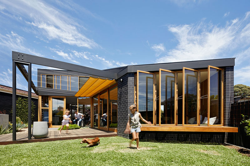 This new extension tucks neatly under the existing eaves with the new spaces wrapping around the original home, which is united by a continuous roofline which folds overhead. #HouseExtension #HouseAddition #Architecture