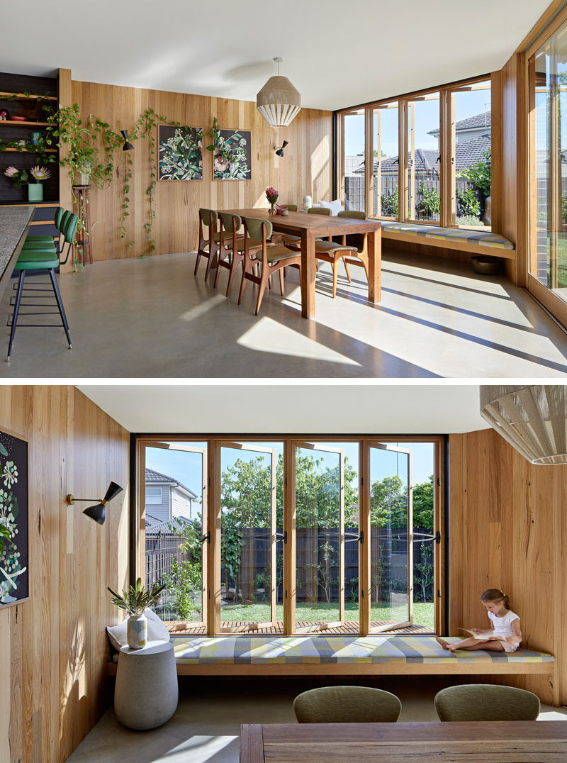 A built-in window seat pops out from this dining room to give the kitchen and dining area light and views of the backyard. #WindowSeat #DiningRoom #Windows