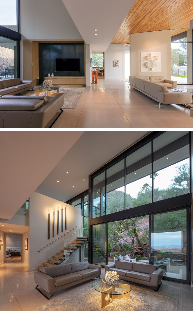 This modern house has a casual living room with a high ceiling and access to a small patio outside. #LivingRoom #Windows