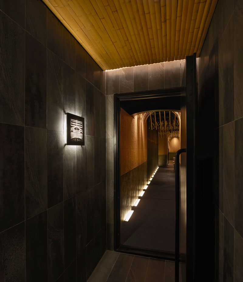 Design Detail - Imafuku Architects designed a Japanese restaurant that features a bamboo entryway that uses bamboo strips to create an arch on the ceiling. #Bamboo #RestaurantDesign #InteriorDesign