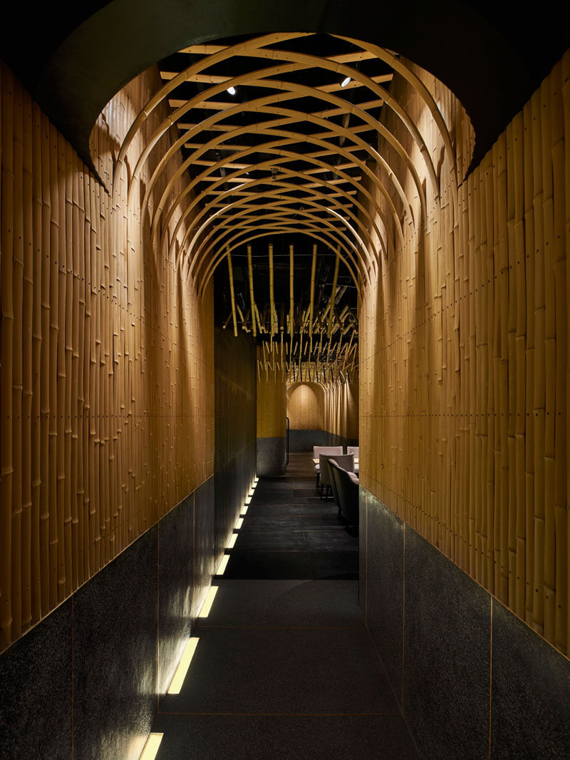 Design Detail - Imafuku Architects designed a Japanese restaurant that features a bamboo entryway that uses bamboo strips to create an arch on the ceiling. #Bamboo #RestaurantDesign #InteriorDesign