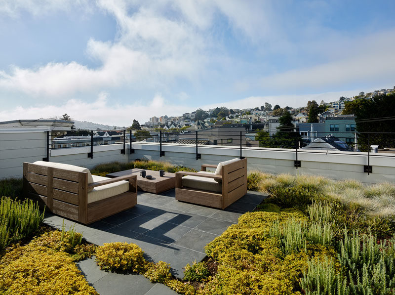 On this roof deck, there's a small sitting area that's surrounded by a succulent garden. #RoofDeck #SucculentGarden #GreenRoof