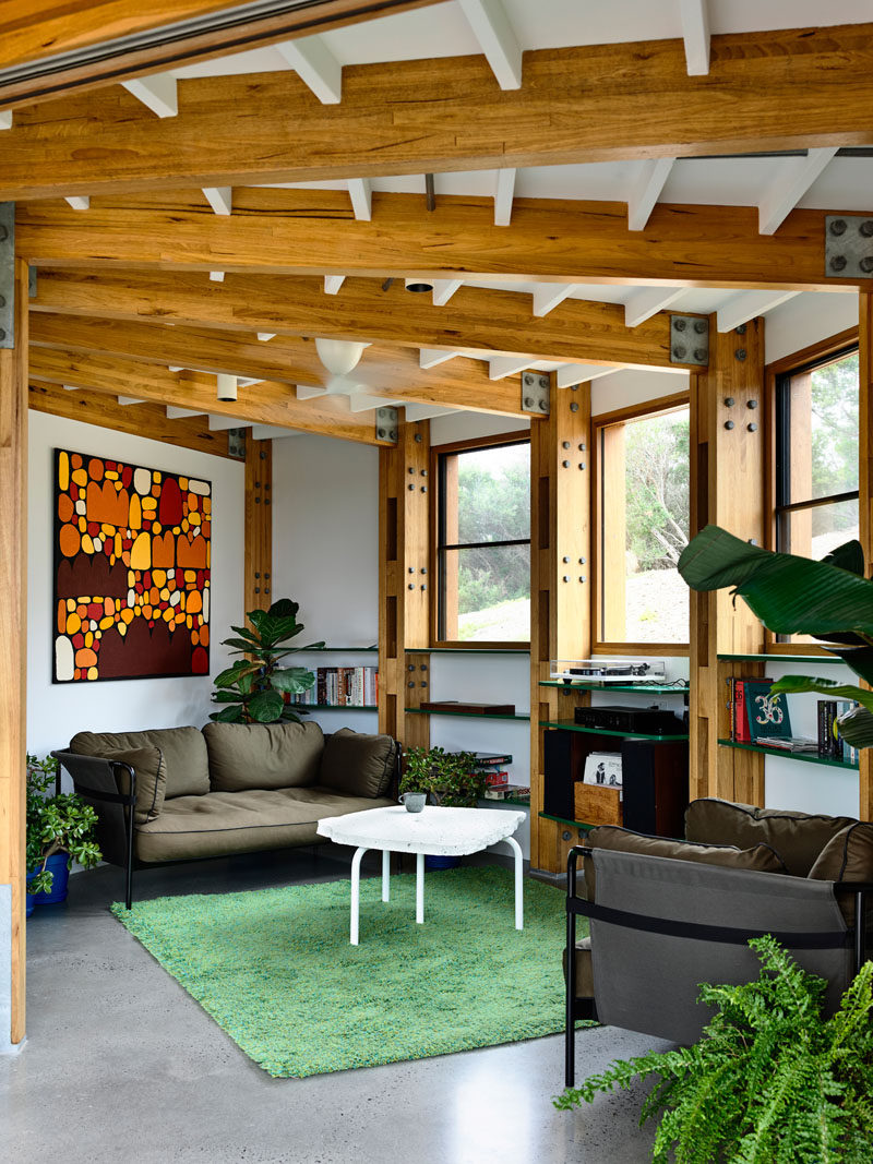 Windows provide views of the bush, rugged sand dunes, and scrub, that surround this circular house. #LivingRoom #CircularHouse