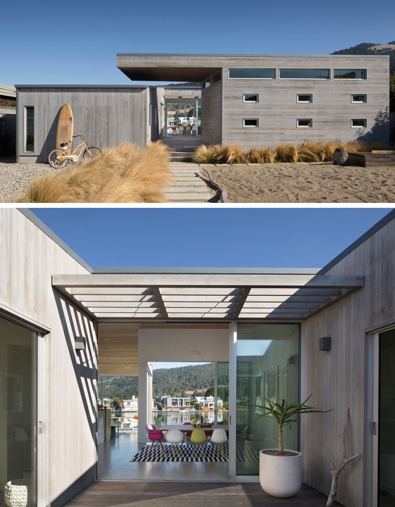 The exterior of this modern house is clad in clear-heart western red cedar, that's been stained grey for a weathered look. #Architecture #WoodSiding #ModernHouse