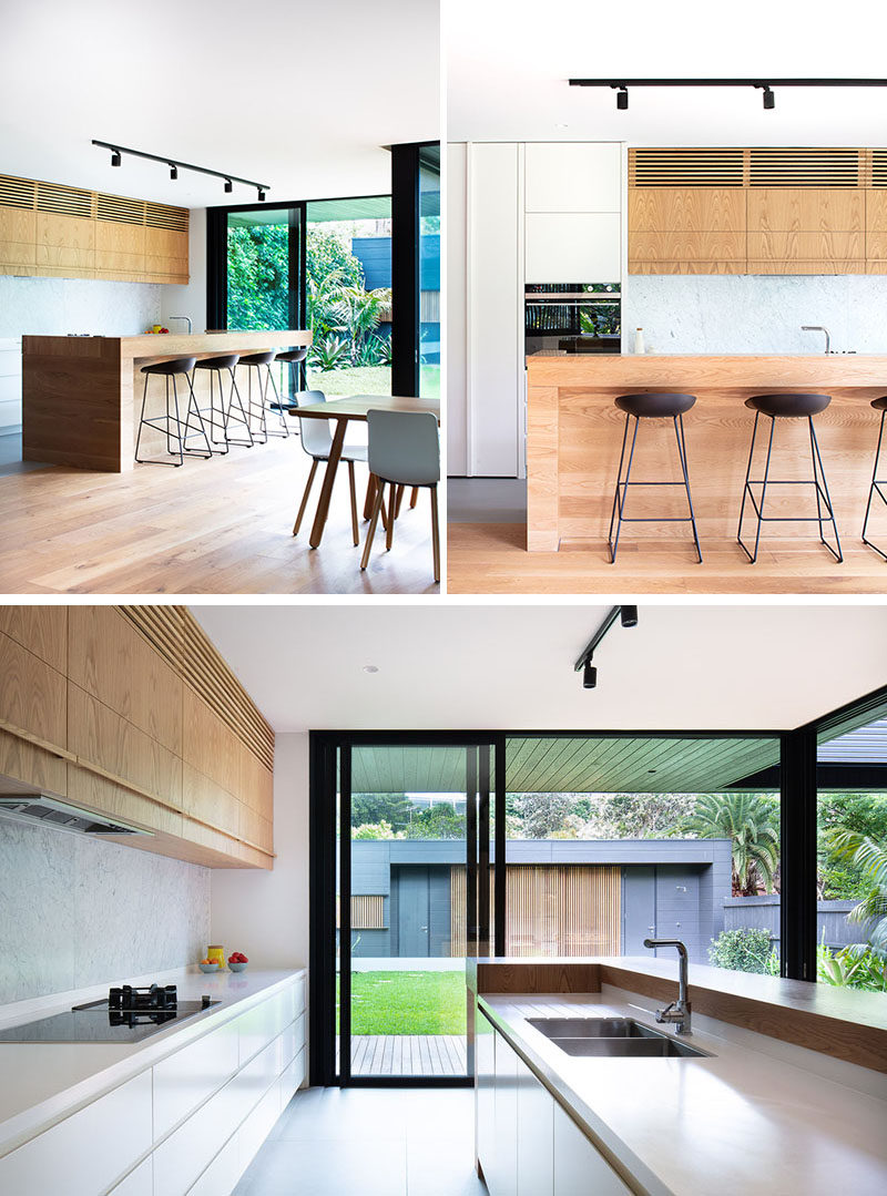 In this kitchen, there's an American Oak solid timber kitchen island, that when paired with white countertops and cabinetry, creates a modern yet relaxed design. #KitchenDesign #ModernKitchen #WoodKitchenIsland