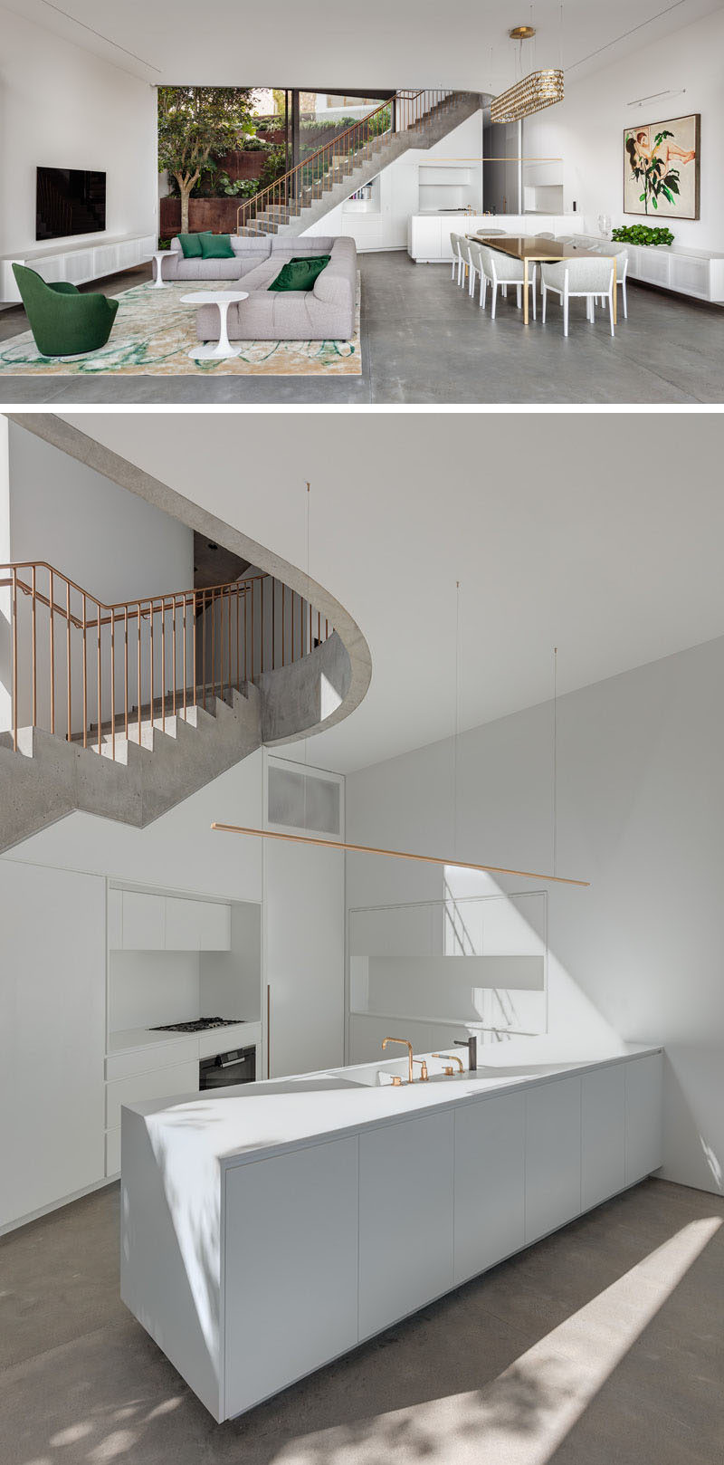 This modern house has an all white kitchen with an island, and cabinets that seamlessly blend into the walls. #WhiteKitchen #ModernKitchen #OpenPlanInterior