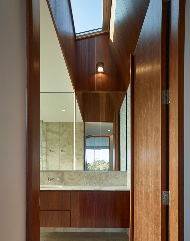 Skylights add natural light to the interior of this modern house, and the angled lines are highlighted by the use of wood. #Skylight