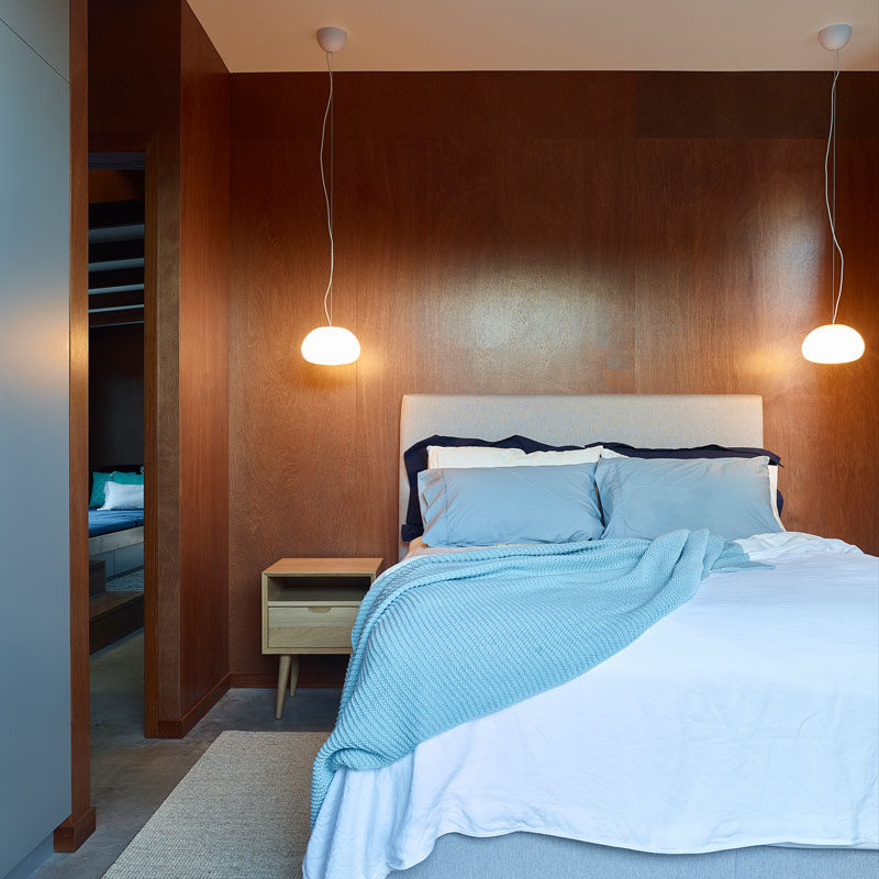 In this bedroom, two simple pendant lights hang above bedside tables on either side of the bed. #BedroomDesign