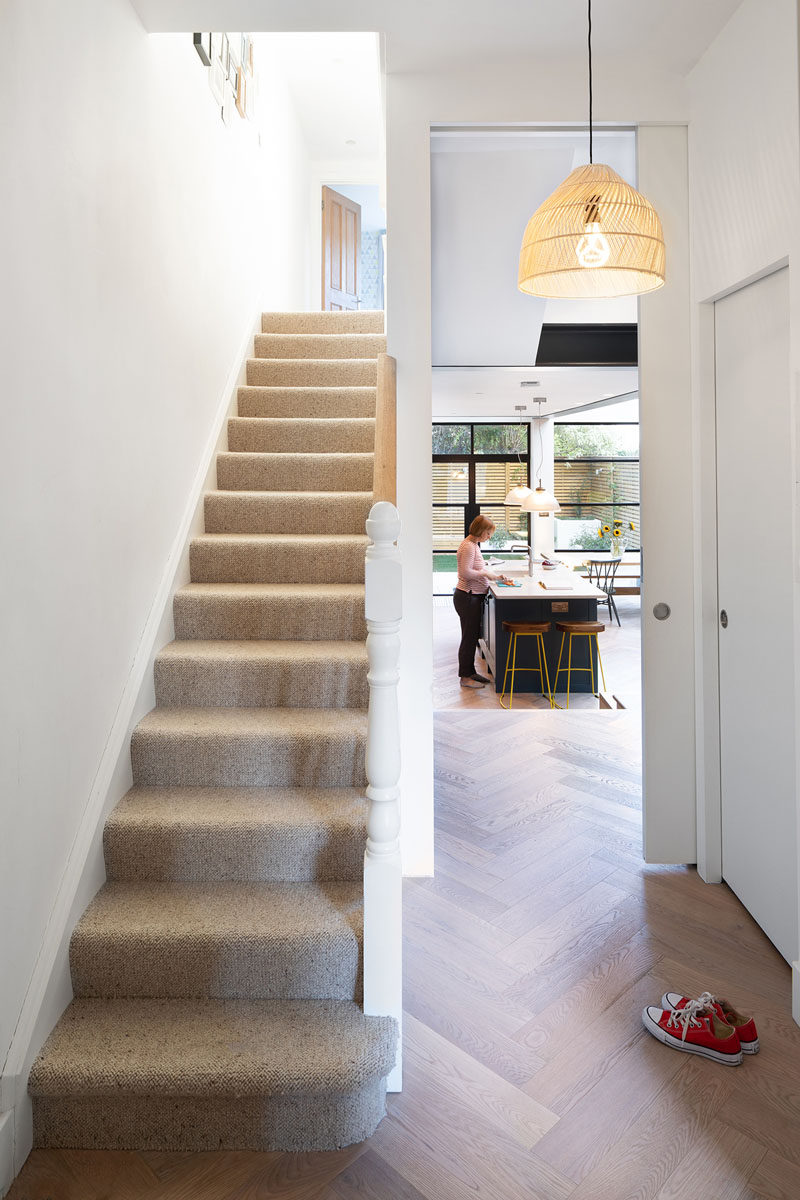 In the entryway of the home, there's a tall pocket door that opens to reveal the new extension. #PocketDoor