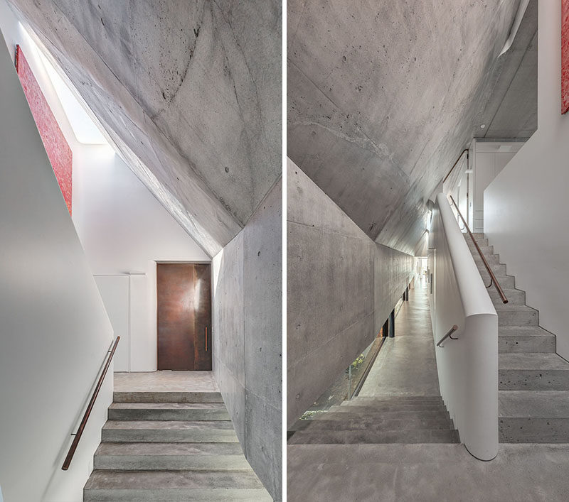 Stepping inside this modern house, there's a series of volumes defined by concrete and white walls. #ConcreteStairs #ModernHouse