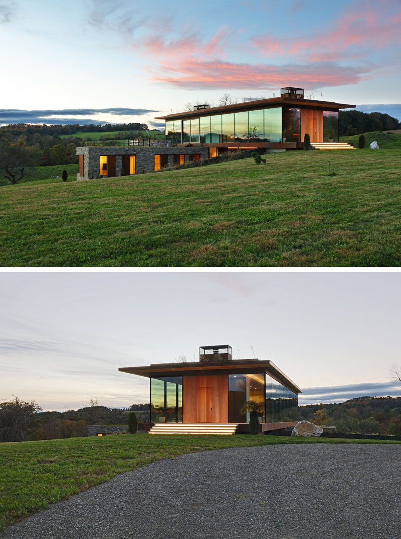 Upon arrival at this modern house, guests are greeted by wide steps with hidden lighting, and a wood front door that blends in with the door surround. #ModernHouse #FrontDoor #ExteriorSteps